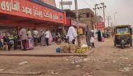 People queue for bread in front of a bakery in Omdurman on July 15, 2023. Since April 15, 2023, the forces the Sudanese army chief have been at war with the paramilitary Rapid Support Forces (RSF) paramilitary group. (Photo by AFP)
