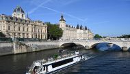 A Peniche boat sails past the Quai de l'Horloge during a parade on the River Seine in Paris on July 17, 2023, to test 