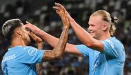 Manchester City forward Erling Haaland (R) is congratulated by defender Joao Cancelo for his goal during the J-League World Challenge 2023 football match between English Premier League champion Manchester City and Yokohama F-Marinos at the National Stadium in Tokyo on July 23, 2023. (Photo by Toshifumi KITAMURA / AFP)
