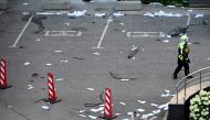 A firefighter walks among papers and broken glass outside a damaged office block of the Moscow International Business Center (Moskva City) following a reported drone attack in Moscow on July 30, 2023. (Photo by Alexander Nemenov / AFP)