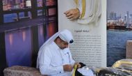 A craftsman works at Qatar's pavilion.