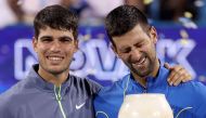 Carlos Alcaraz of Spain and Novak Djokovic of Serbia pose with their trophies after the final of the Western & Southern Open at Lindner Family Tennis Center on August 20, 2023 in Mason, Ohio. Photos by Matthew Stockman/Getty Images/AFP