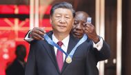 South African President Cyril Ramaphosa bestows the Order of South Africa to President of China Xi Jinping during Jinping's state visit at the Union Buildings in Pretoria on August 22, 2023. (Photo by Phill Magakoe / AFP)