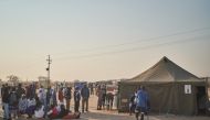 Voters wait to cast their votes next to a polling station during Zimbabwe's presidential and legislative elections in Bulawayo on August 23, 2023. (Photo by Zinyange Auntony / AFP)