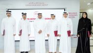 QIC Group Chief Administrative Officer, Rashid Al Buainain (third left) with students during the conclusion of Summer Internship Program, yesterday.