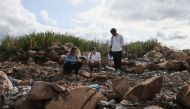 Environmental activists (L-R) Egor Chastukhin, Alexei Zetkin and Yakov Demidov inspect a landfill on the outskirts of Penza on August 22, 2023. (Photo by Olesya Kurpyayeva / AFP)
