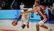 France's Sylvain Francisco (L) dribbles the ball as Latvia's Arturs Zagars tries to block during the FIBA Basketball World Cup group G match between France and Latvia at Indonesia Arena in Jakarta on August 27, 2023. (Photo by Yasuyoshi CHIBA / AFP)
