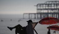 Beachgoers enjoy the sun and the sea on the beach at Brighton, on the south coast of England on September 7, 2023, as the late summer heatwave continues. (Photo by Daniel LEAL / AFP)