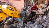 Rescuers use a small excavator to search for survivors under the rubble of a collapsed house in Moulay Brahim, Al Haouz province, on September 9, 2023. Photo by FADEL SENNA / AFP
