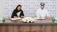 Qatar Credit Bureau CEO, Sheikha Maryam bint Khalifa Al Thani and Ali Abdulrahman Al Muftah on behalf of Al Tadamon Motors & Trading during the signing of agreement.