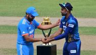 India's captain Rohit Sharma (L) and Sri Lanka's captain Dasun Shanaka shake hands beside the trophy before the start of the Asia Cup 2023 in Colombo on September 17, 2023. (Photo by Ishara S. Kodikara / AFP)