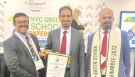 QLA Director Jameel Al Shammari (centre) receiving the award. 