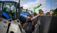 A farmer stands in front of a tractor during a protest against the lifting of ban on imports of grain coming from Ukraine, in Dragoman, near the border with Serbia, on September 18, 2023. (Photo by Nikolay DOYCHINOV / AFP)
