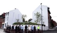 People observe a minute of silence during the inauguration of a Memorial garden dedicated to victims of serial child-killer Marc Dutroux in Charleroi. (Photo by Kenzo Tribouillard / AFP)