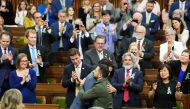 Ukrainian President Volodymyr Zelensky (right) receives a hug from Canadian Prime Minister Justin Trudeau after addressing the House of Commons in Ottawa, Canada, on September 22, 2023. (Photo by Sean Kilpatrick / POOL / AFP)