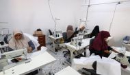 Participants work at a women's training and development center in Tripoli on September 23, 2023. (Photo by Mahmud Turkia / AFP)
