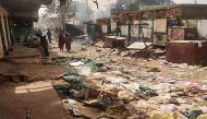 File Photo: People walk among scattered objects in the market of El Geneina, the capital of West Darfur on April 29, 2023. (AFP)

