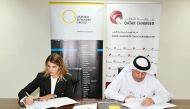 Director of Administrative and Finance Affairs at QC, Hussain Yousef Al Abdulghani and OBG’s Country Director, Fernanda Braz signing the MoU at the 
chamber’s headquarters.