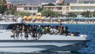 (Files) In this file picture migrants arrive on a Guardia di Finanza ship, in the harbour of Italian island of Lampedusa, on September 15, 2023. 