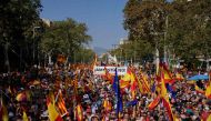 Protesters hold Spain's, EU's flags and 'No to amnesty' signs during a right-wing protest against plans to grant Catalan separatists an amnesty in order to form Spain's next government, in Barcelona on October 8, 2023.(Photo by Pau BARRENA / AFP)
