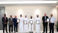 Qatar Primary Materials Company officials recieving the ISO certifications.