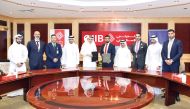 QIIB CEO, Dr. Abdulbasit Ahmad Al Shaibei ; FynPay and PeyzBank Group Chief Executive Officer and Co-Founder, Rauf Azam with other officials at the MoU signing at QIIB headquarters.