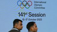 Venue staff walk past a digital screen on the first day of the 141st Session of the International Olympic Committee (IOC), in Mumbai on October 15, 2023. Photo by INDRANIL MUKHERJEE / AFP