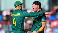 South Africa's Gerald Coetzee (right) celebrates with Aiden Markram after taking the wicket of Pakistan's Mohammad Rizwan during the 2023 ICC Men's Cricket World Cup one-day international (ODI) match between Pakistan and South Africa at the MA Chidambaram Stadium in Chennai on October 27, 2023. (Photo by R.Satish Babu / AFP) 