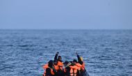 (Files) Migrants travel in an inflatable boat across the English Channel, bound for Dover on the south coast of England. (Photo by Ben Stansall / AFP)