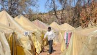 A displaced Moroccan man walks in a temporary camp set up following the September 8 earthquake, in the hamlet of Imzilne in the Ouirgane commune, some 60 kilometres south of Marrakesh, on November 27, 2023. Photo by AFP