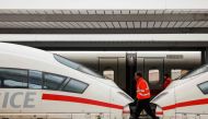 Employees walk past ICE highspeed trains that are standing still in the main train station of Munich, southern Germany, during a wage strike by German train drivers on December 8, 2023. Photo by Michaela Rehle / AFP