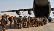 The last French soldiers board a French military plane to leave Niger for good, at the French base which was handed over to the Nigerien army, in Niamey on December 22, 2023. (Photo by Boureima Hama / AFP)