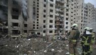 Firefighters work in a multi-storey residential building destroyed by a missile attack in central Kyiv, on January 2, 2024. (Photo by Genya Savilov / AFP)