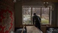 A man stands inside his damaged apartment following an overnight shelling in Myrnohrad, Donetsk region, on January 26, 2024, amid the Russian invasion of Ukraine. (Photo by Roman PILIPEY / AFP)