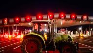 Protesting farmers blockade the A10 highway with tractors during a protest against taxation and declining income, near the Peage de Saint-Arnoult-en-Yvelines toll gates southwest of Paris, on January 26, 2024, as part of a nationwide day of protests called by several farmers unions on pay, tax and regulations. (Photo by Dimitar DILKOFF / AFP)
