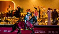 Saudi Arabia's Abdullah Alsharbatly celebrates astride Alamo after winning the CS15* - 1.60m Grand Prix title.