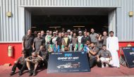 Team QMMF's drivers and officials celebrate after the title win. 
