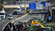 Tractors are parked on the highway during a protest near Parets del Valles, around 20 km north of Barcelona, on February 7, 2024. Photo by Pau Barrena / AFP