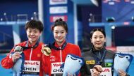 Gold medallist China’s Chang Yani (centre), silver medallist China’s Chen Yiwen (left) and bronze medallist South Korea’s Kim Su-ji pose after the medal ceremony yesterday. AFP 