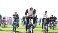 Speaker of the Council H E Hassan bin Abdullah Al Ghanim and other officials cycle during the National Sport Day activities at Aspire Park yesterday. 