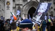 Demonstrators hold placards as they protest outside The Royal Courts of Justice, Britain's High Court, in central London on February 20, 2024, as the high court hears the final UK appeal by WikiLeaks founder Julian Assange against his extradition to the US. (Photo by JUSTIN TALLIS / AFP)
