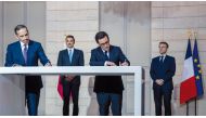 Amir H H Sheikh Tamim bin Hamad Al Thani and French President H E Emmanuel Macron witness signing of an agreement.
