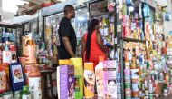 Customers approach a shop selling skin lightening cosmetic products at the Koumassi market, in Abidjan on February 26, 2024. (Photo by Sia Kambou / AFP)