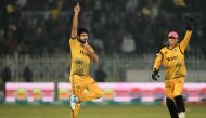 Peshawar Zalmi's Aamer Jamal (L) celebrates after taking the wicket of Multan Sultans' Tayyab Tahir during the Pakistan Super League (PSL) Twenty20 cricket match between Multan Sultans and Peshawar Zalmi at the Rawalpindi Cricket Stadium in Rawalpindi on March 5, 2024. (Photo by Aamir QURESHI / AFP)