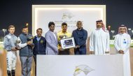 The connections of X Force pose for a photo with officials after winning the Fuwairit Cup at QREC's 32nd Al Rayyan Meeting yesterday. 
