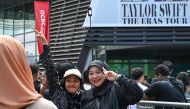 Fans of US singer Taylor Swift, also known as Swifties, take photos as they arrive for the pop star's Eras Tour concert at the National Stadium in Singapore on March 7, 2024. (Photo by Roslan Rahman / AFP)