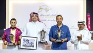 The connections of Safi Al Zaman pose for a photo after receiving their trophies from QREC Racing Manager Rashid Al Kubaisi (right).   

