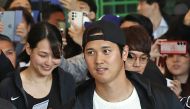 Los Angeles Dodgers Shohei Ohtani (C) arrives with his wife Mamiko Tanaka (L) and his team's players at Incheon International Airport in Incheon on March 15, 2024, ahead of the 2024 MLB Seoul Series baseball games between Los Angeles Dodgers and San Diego Padres. (Photo by YONHAP / AFP) 