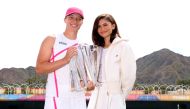 Iga Swiatek of Poland poses for a photograph with Hollywood actress Zendaya and the winners trophy after her straight sets victory against Maria Sakkari of Greece in the Women's Final during the BNP Paribas Open at Indian Wells Tennis Garden on March 17, 2024 in Indian Wells, California. (Photo by CLIVE BRUNSKILL / GETTY IMAGES NORTH AMERICA / Getty Images via AFP)
