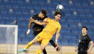 Al Gharafa's Ahmed Alaaeldin (front) vies for the ball possession with an Al Rayyan player. 